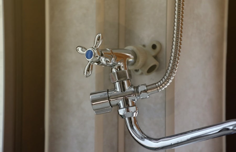 Silvery shower in modern hotel bathroom with natural light